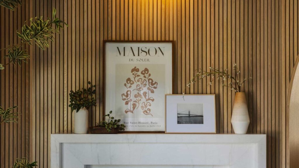 Wood-paneled wall with decorative plants, a framed 