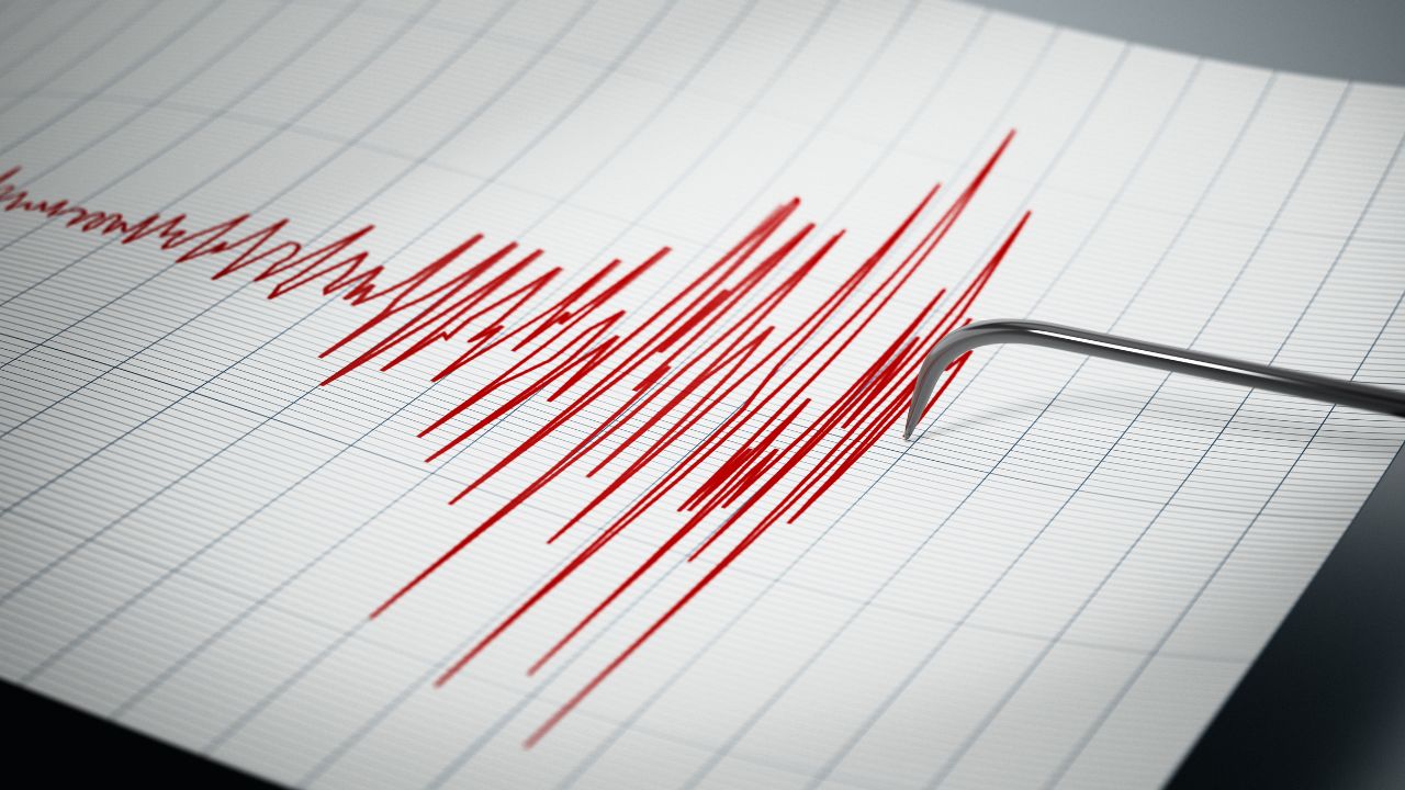 A seismograph drawing red, jagged lines on graph paper signals earthquake activity, providing vital data for general contractors assessing structural safety.